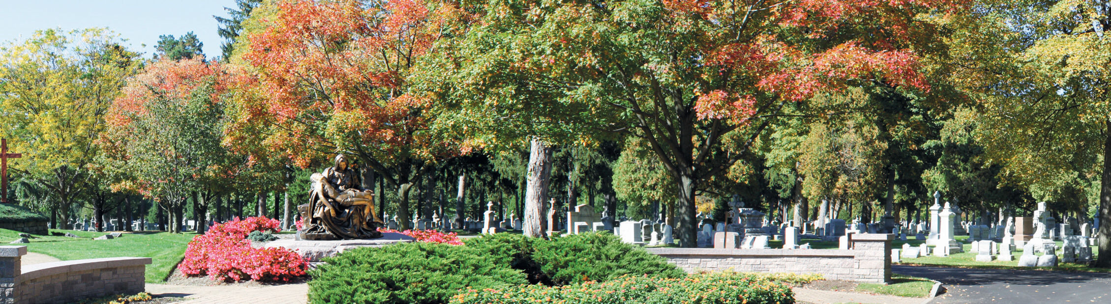 HSAG-Brochure-16 Wide view of a Pieta Monument surrounded by traditional burial areas