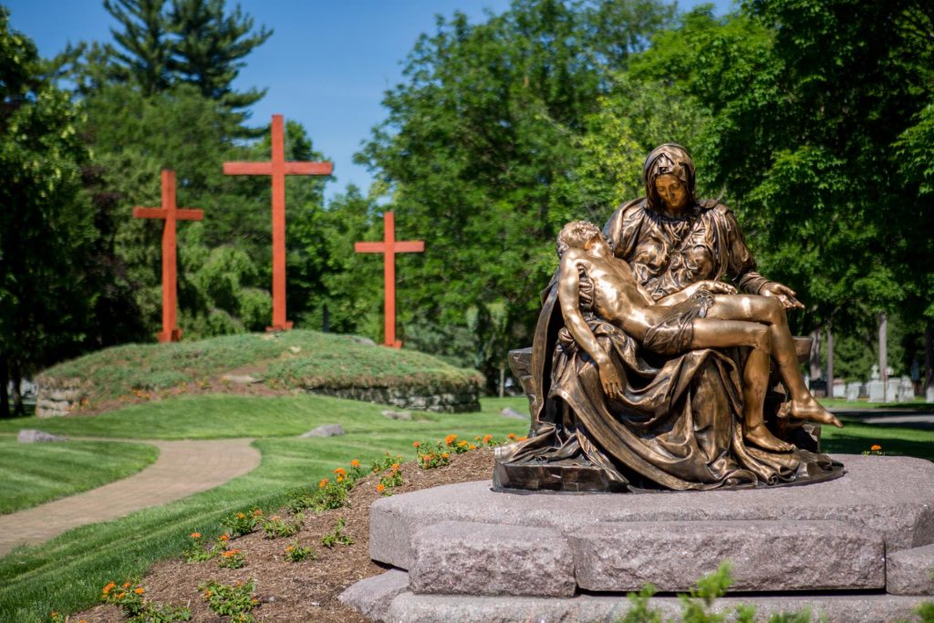 about-us Pieta monument in front of 3 crosses